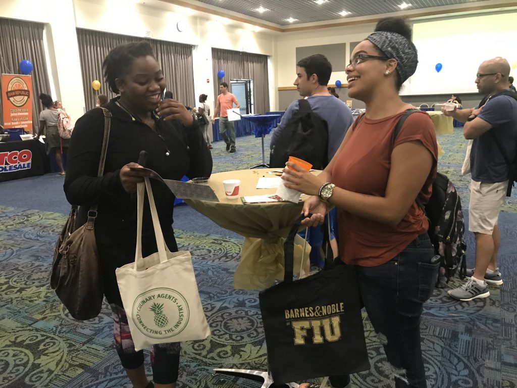 FIU juniors Larissa Rivard and Sabrina Mehu discuss the various activities offered by Ninja Lounge at the BBC Restaurant and Business Fair that took place last Tuesday.